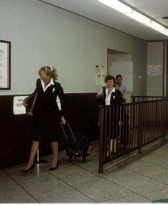 1984 September 11 Pan Am flight attendants exits an aircraft into the terminal , location not known.